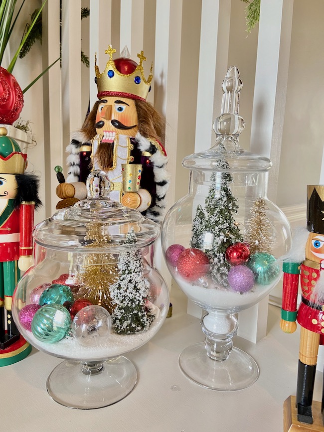 https://perfectingplaces.com/wp-content/uploads/2021/11/decorate_with_bottle_brush_trees_nutcracker_display.jpeg