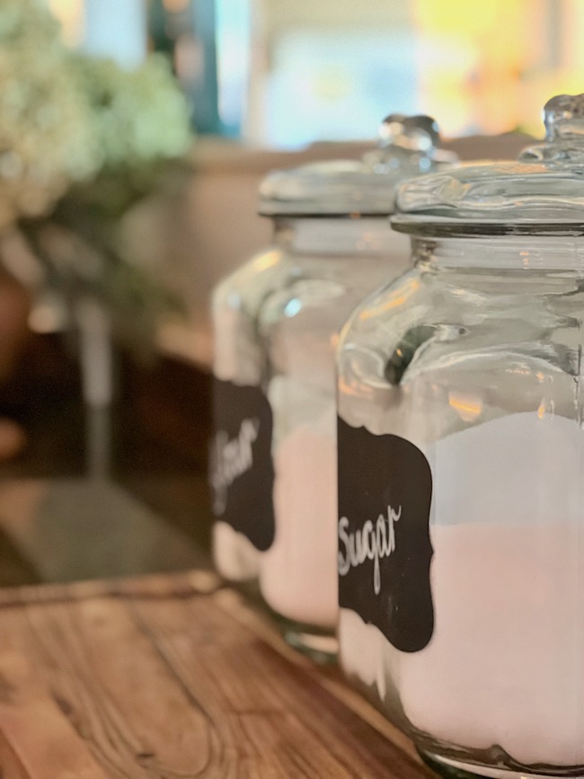 Glass Canisters with Flour and Sugar on Countertops