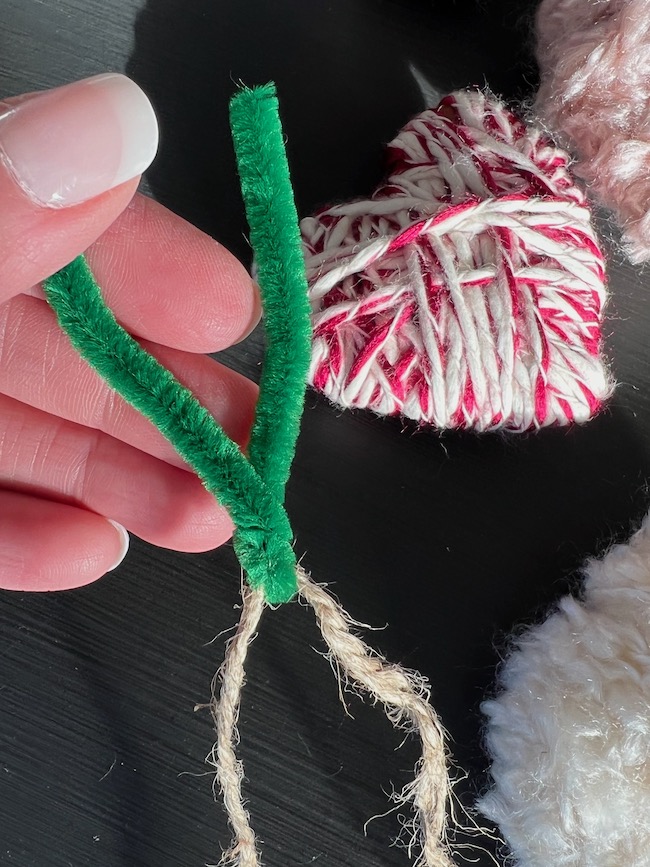 Use a chenille stem or twist tie to make a "needle" for pushing the twine through the hearts.