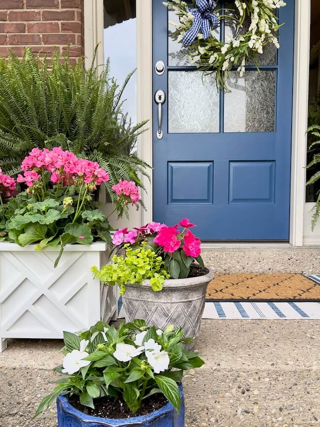 Summer Ideas for Small Porch Decor with Pink Flowers and Blue Door