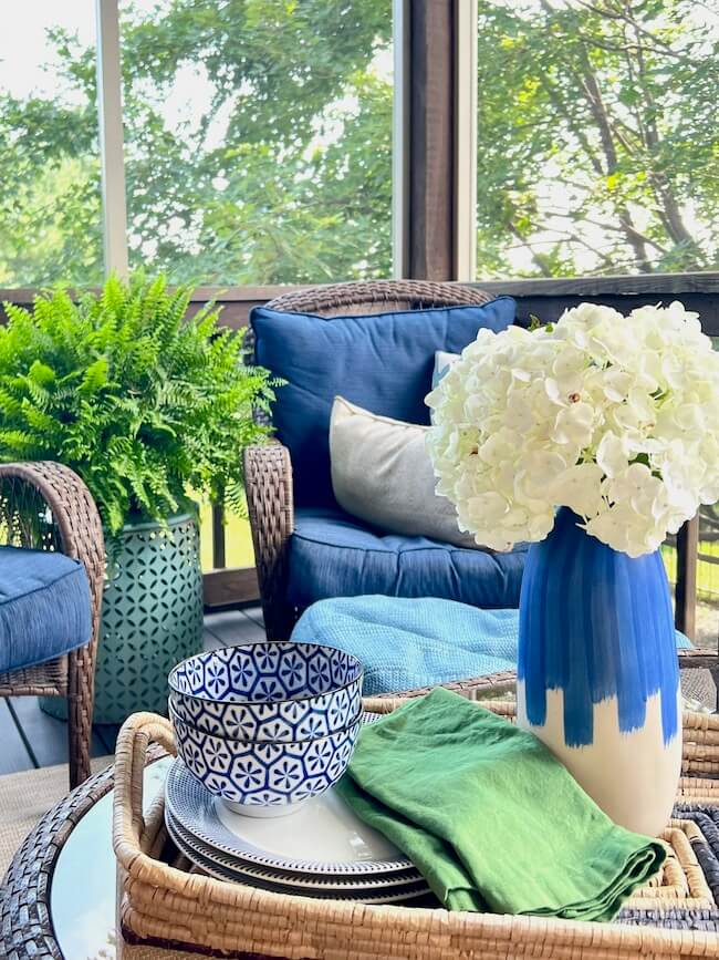 small screen porch decorating ideas - blue cushions in wicker chairs, Boston fern on blue table