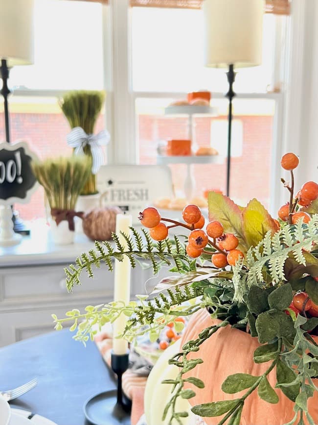 Pumpkin Centerpiece with greenery and orange berries