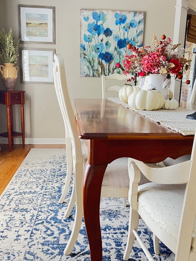 Red fall stems in arrangement with blue rug