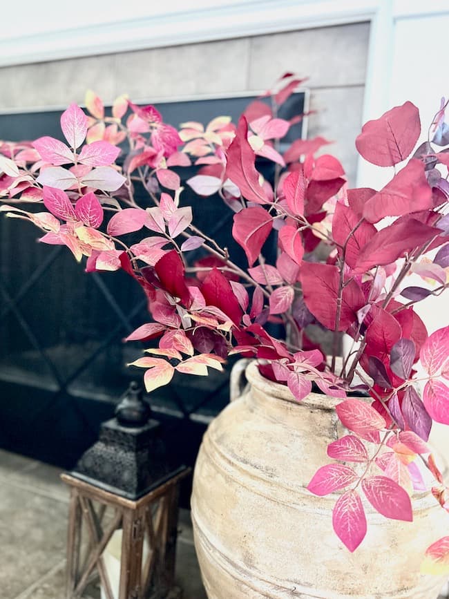 Fall Vase with Red Branches beside Fireplace