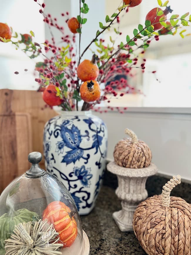 Fall Decorating with Blue and White Ginger Jar and Orange pomegranate sprays on the kitchen counters