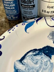 Painting blue and white pumpkins for fall