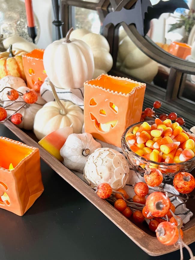 Displaying white mini pumpkins with candy corn in a dough bowl for fall