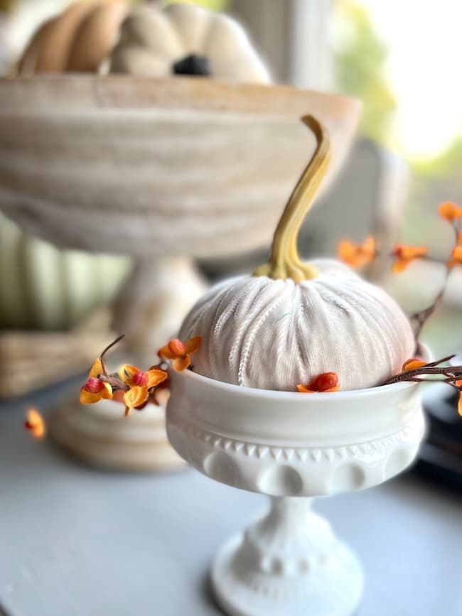 White velvet pumpkin in milk glass bowl