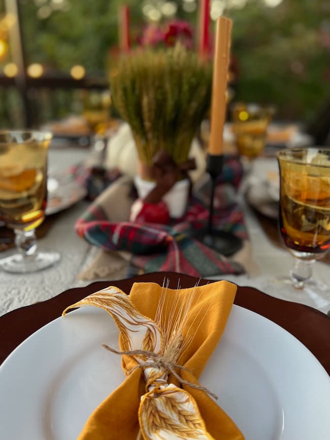 Gold napkins with wheat spray at table setting