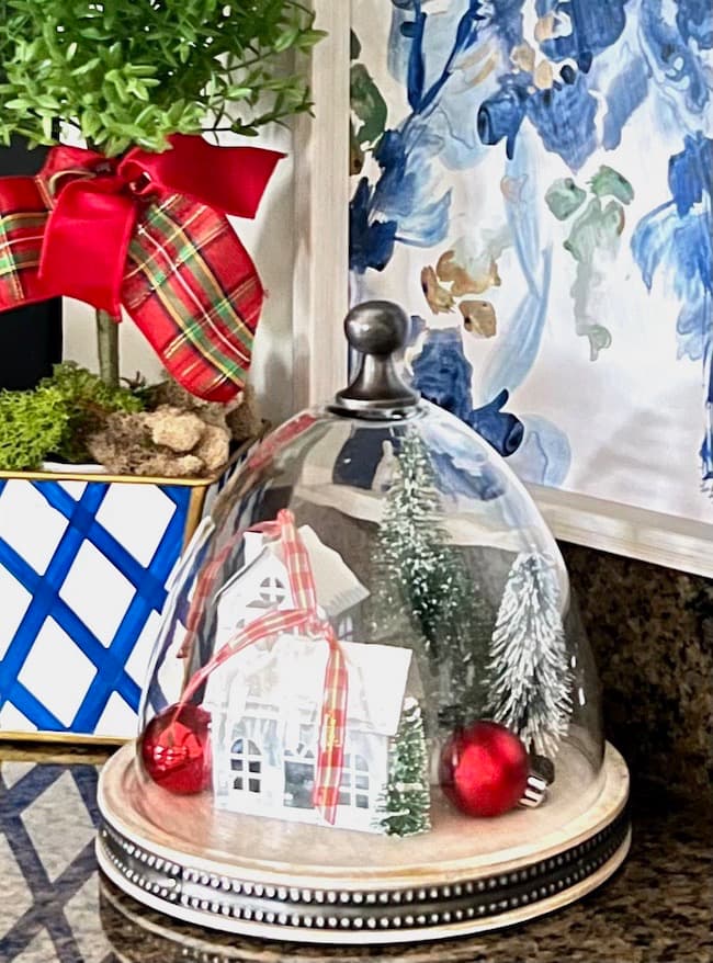 Kitchen Christmas decor with glass cloche and Christmas houses and bottle brush trees