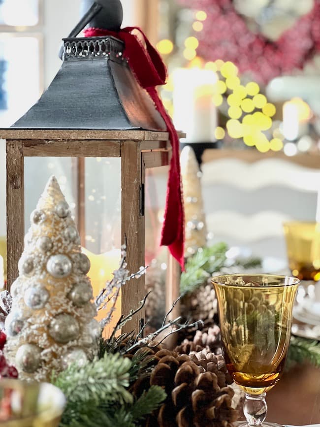 Classic Christmas Decor Christmas Home Tour -- Dining table with lantern centerpiece and red velvet ribbon