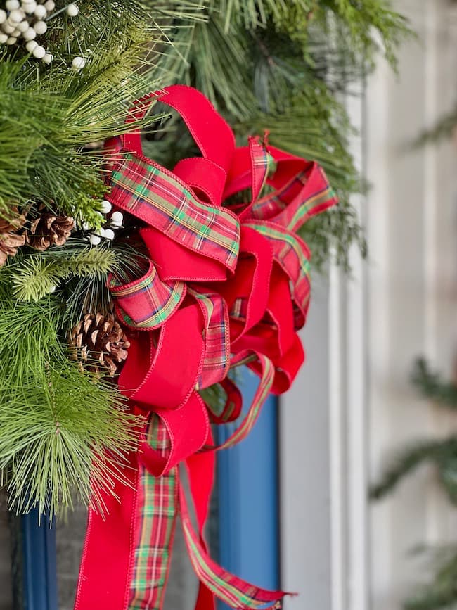 Front Door Christmas wreath in festive plaid and red