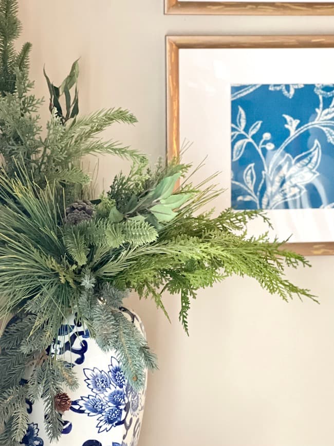 blue and white ginger jar with winter greenery