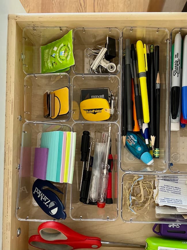 Kitchen drawer organization with plastic drawer organizer bins.