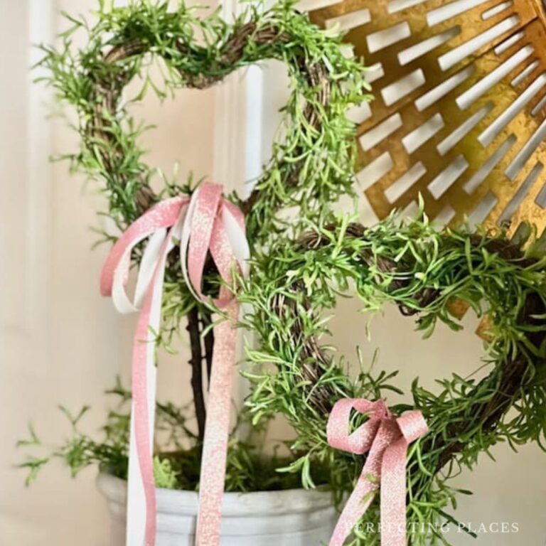 Valentine's Day heart topiaries with pink and white bows.