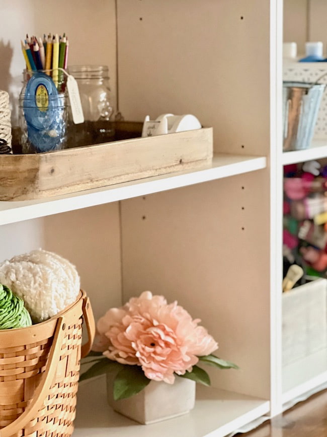 Craft room shelves with organized supplies