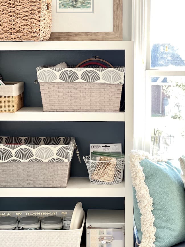 Use bins and baskets to organize craft supplies on built-in bookshelves