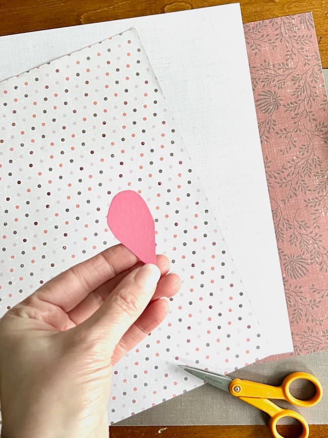 Make a half-heart template for cutting along the fold of the paper.