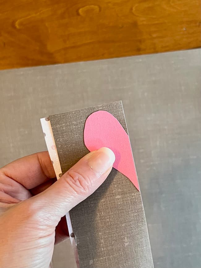 Cut the hearts along the fold of the paper.