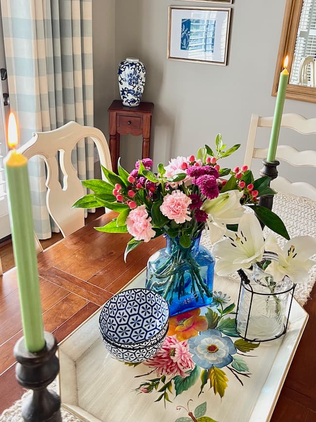 DIy table centerpiece with tole painted tray and flowers in blue glass vase