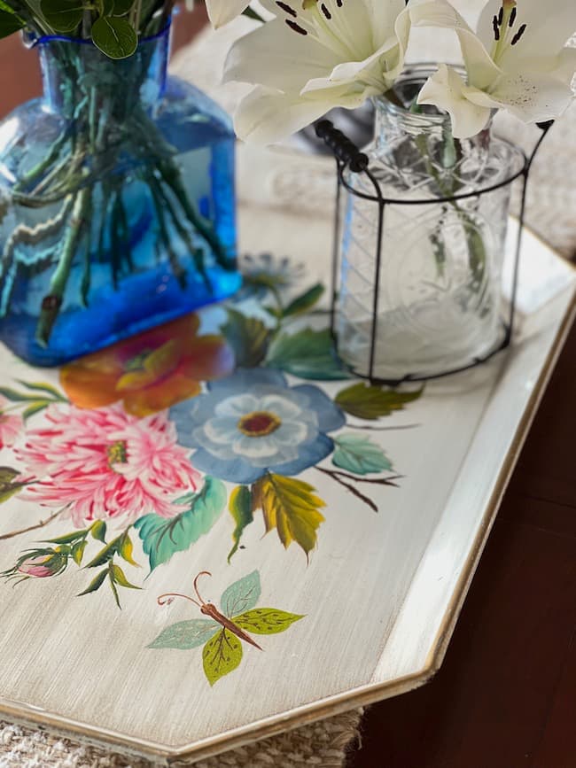 Tole painted tray with blue glass vase for table centerpiece