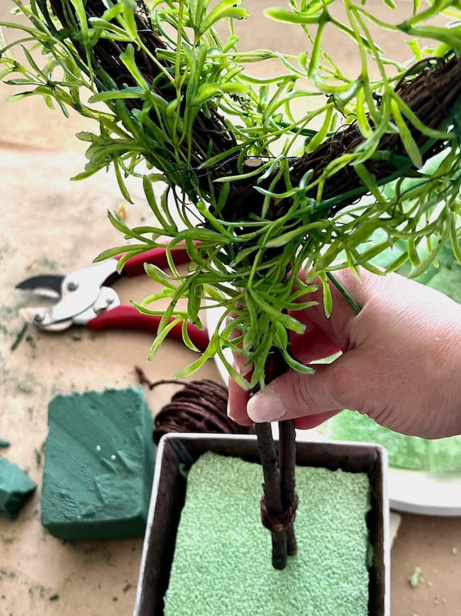 Insert the topiary into the florist foam.