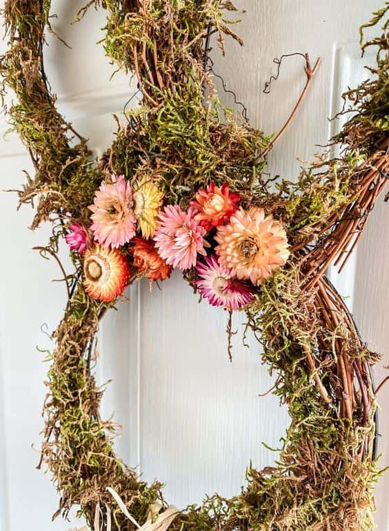 This DIY bunny wreath is made from grapevine, moss, and dried flowers.