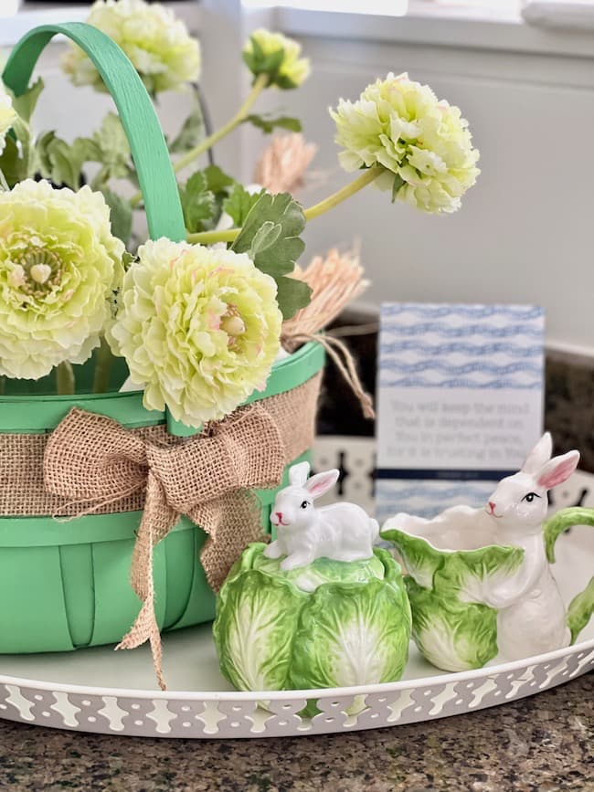 Green Easter basket filled with faux flowers and bunny cabbage sugar and creamer