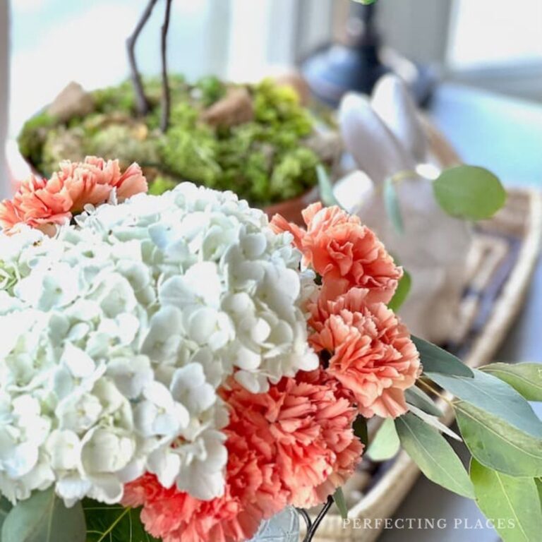 Decorate for spring with beautiful spring flower arrangment with white hydrangea and coral carnations.