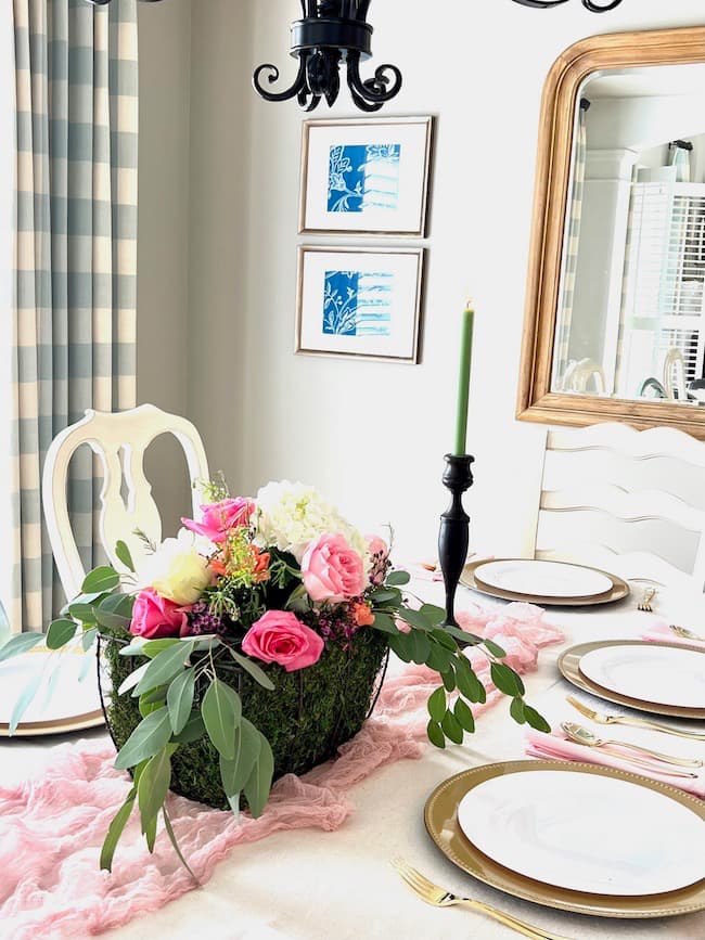 Garden flower shower centerpiece with pink, coral and white flowers, green taper candles and blush cheesecloth table runner