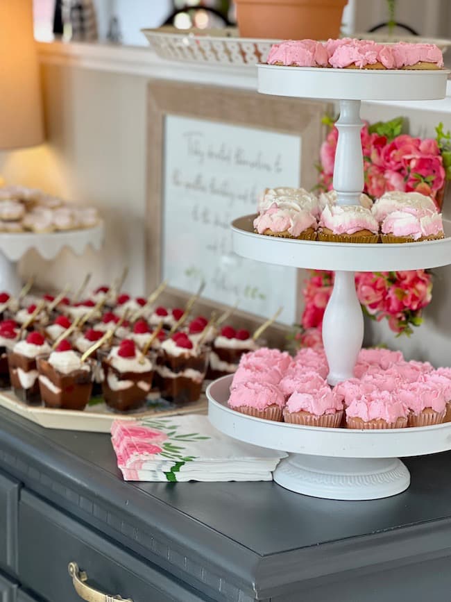 Garden theme baby shower dessert buffet with  trifles and flower cupcakes