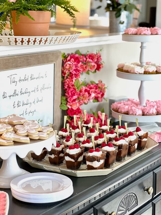 Garden theme baby shower dessert buffet with brownie trifles, sugar cookies, and flower cupcakes