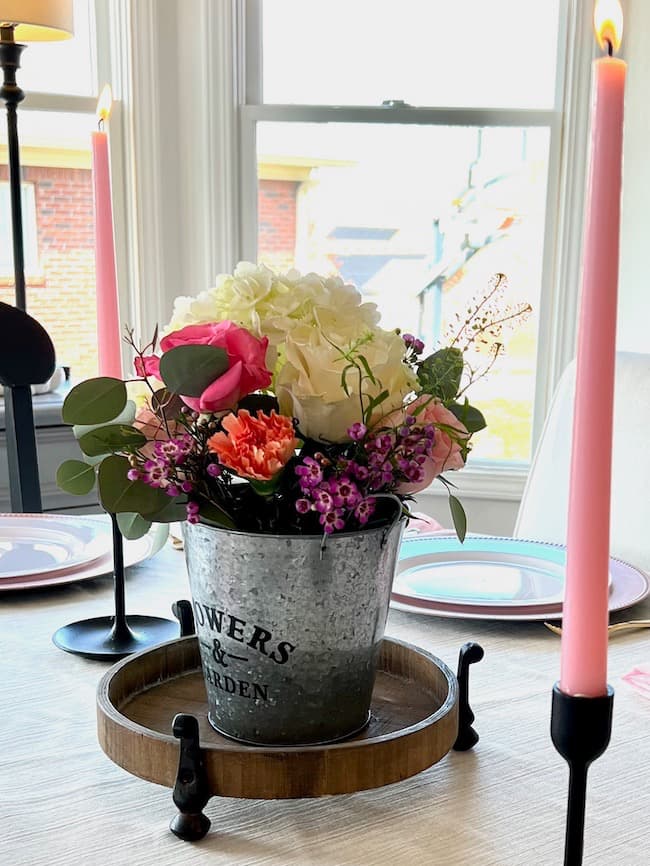 Flower bucket garden flower centerpiece with pink taper candles