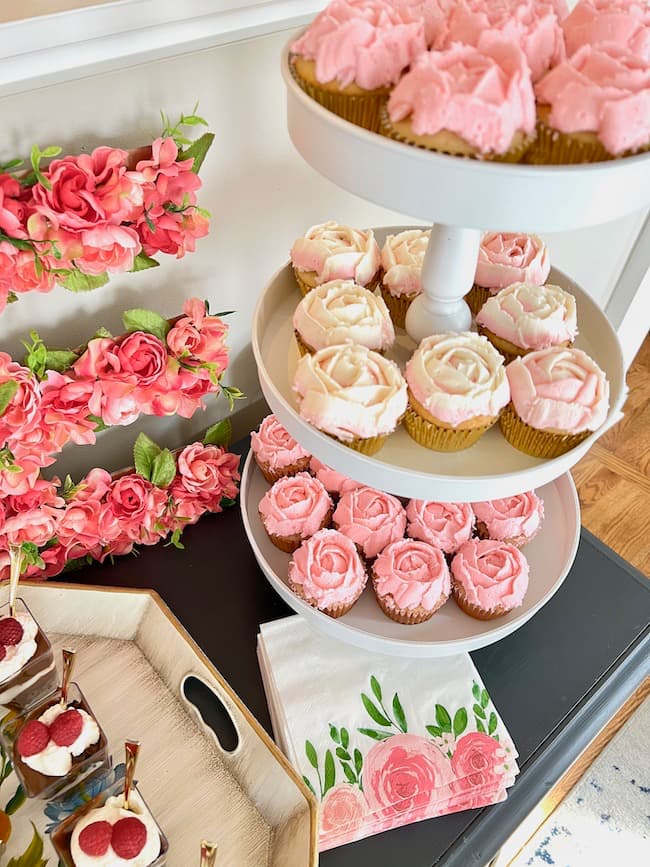 Garden theme baby shower dessert buffet with floral initial, trifles and flower cupcakes