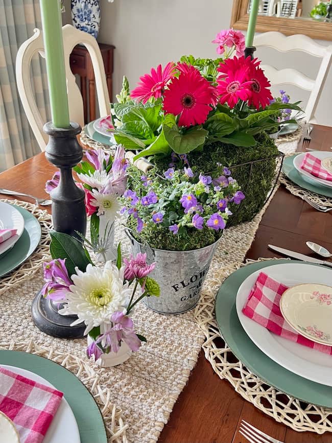 Mother's Day centerpiece with bright pink Gerbera daisies, and purple flowers