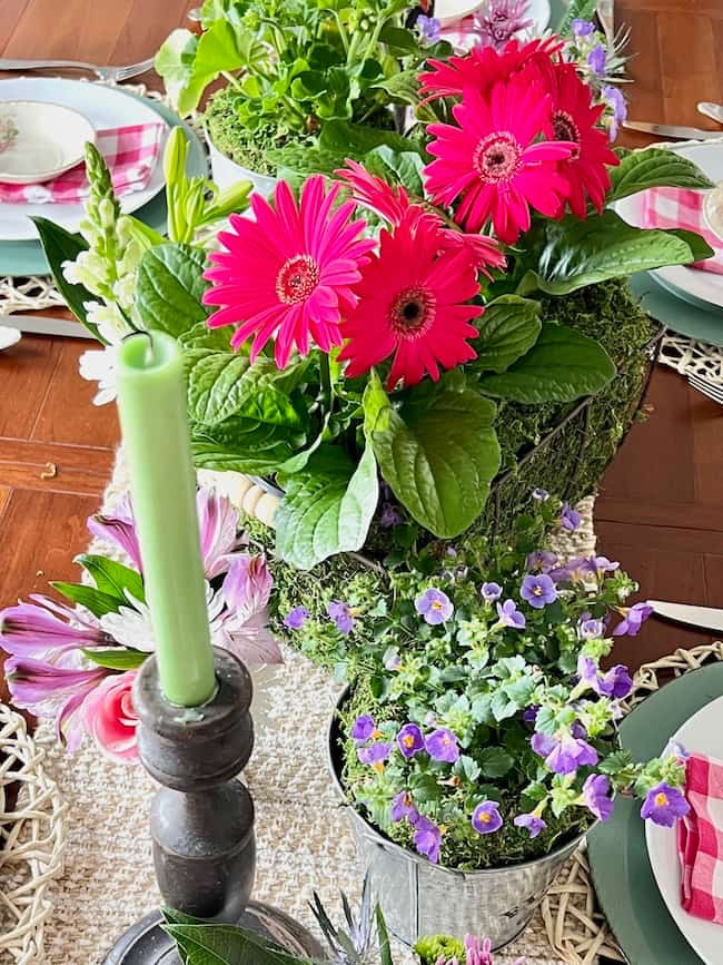 Mother's Day centerpiece with bright pink Gerbera daisies, and purple flowers