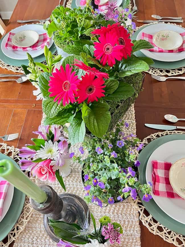 Mother's Day centerpiece with bright pink Gerbera daisies, and purple flowers