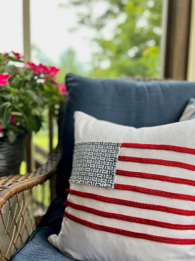 DIY patriotic no sew flag pillow from fabric scraps and decorative trim on the screened porch