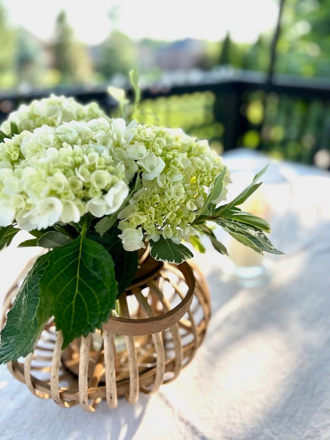 White hydrangea centerpiece in wooden lantern