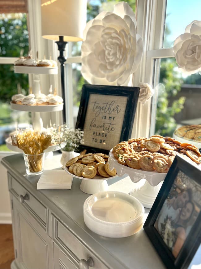 Engagement party dessert table with cupcakes and cookies