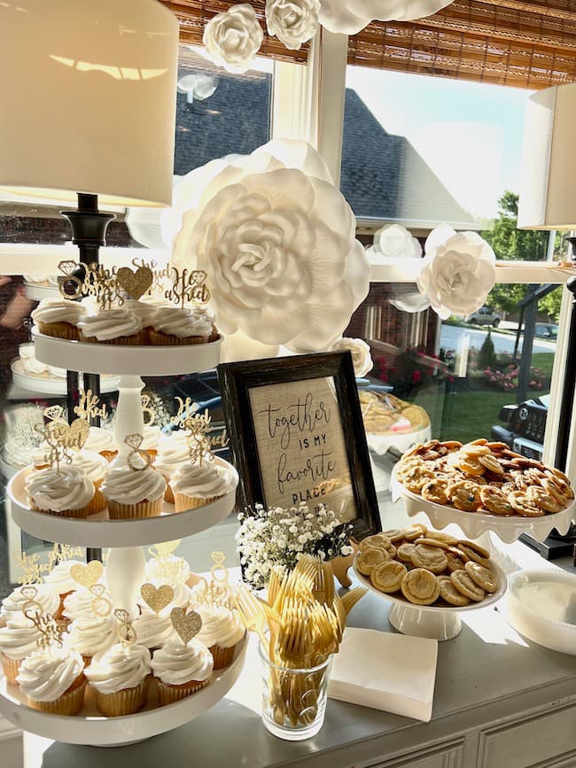 Engagement party dessert table with cupcakes and cookies