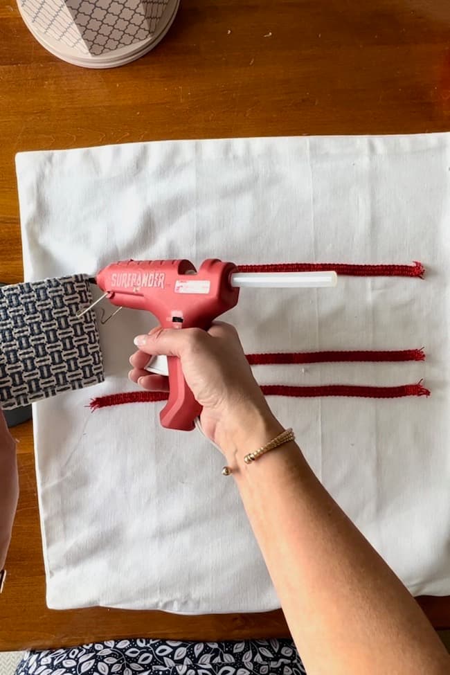 Glue the blue and white fabric on to form the field of stars for the flag.