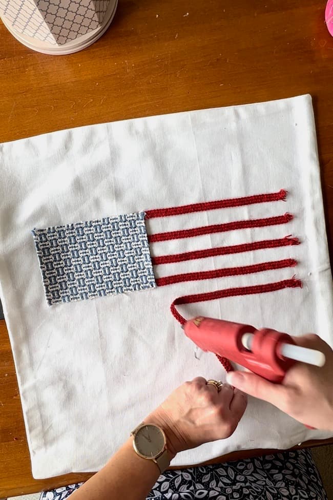 Glue on the red stripes with a glue gun.
