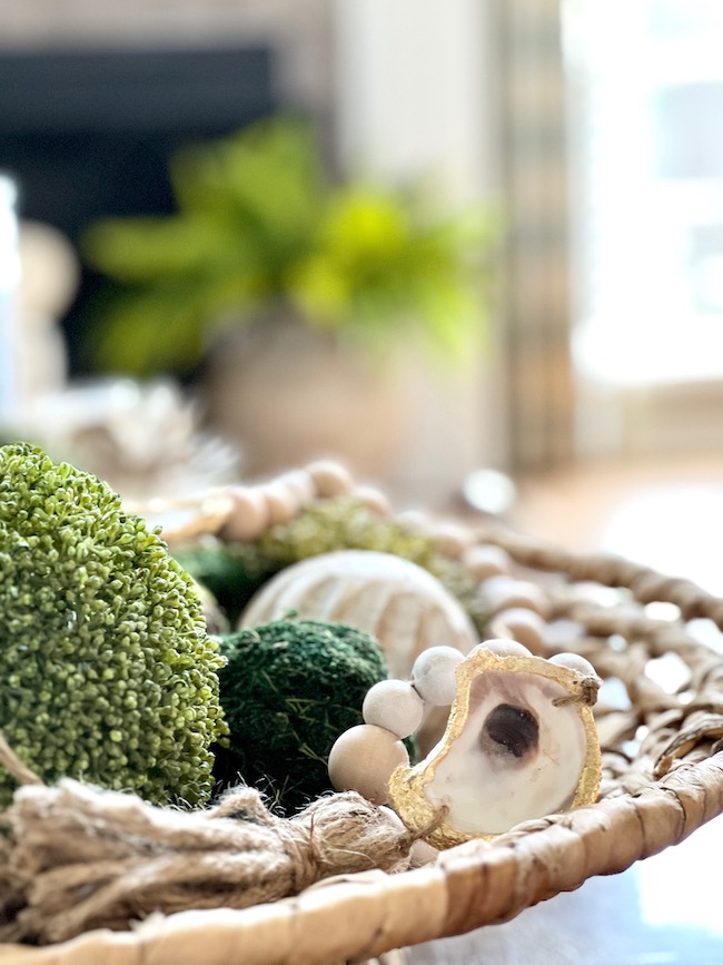 Oyster shell beaded garland with moss balls in a bowl