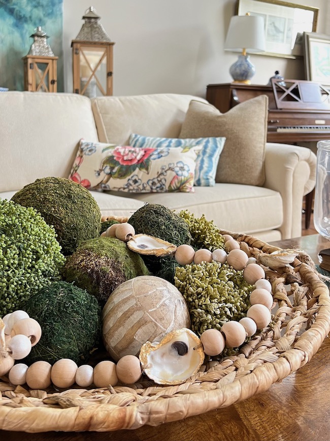 Living room vignette with oyster garland and moss balls.