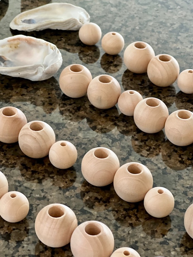 Wooded beads and oyster shell for a diy garland