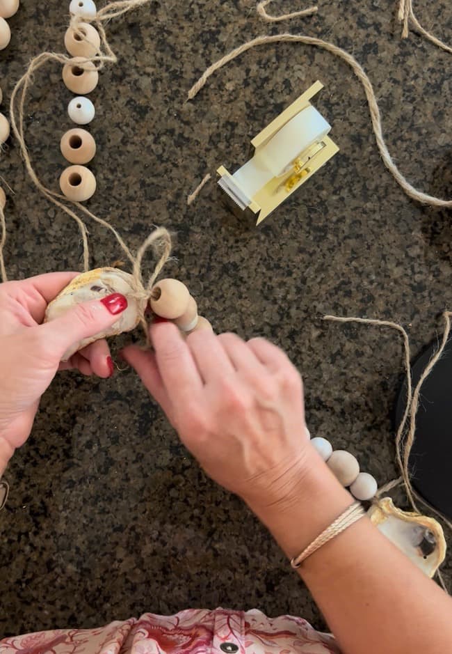 Tie this section of beads to the next oyster shell