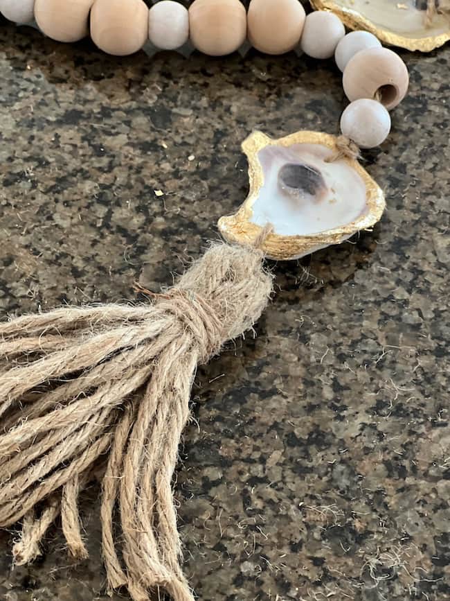 Jute tassel tied to the oyster at the end of the oyster shell garland
