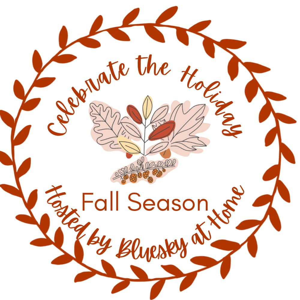 Wreath of red leaves encircles the text "Celebrate the Holiday Fall Season Hosted by Bluesky at Home." Inside the wreath is a graphic of autumn leaves and acorns in red, brown, and beige tones. Start decorating for fall with this charming seasonal invitation!