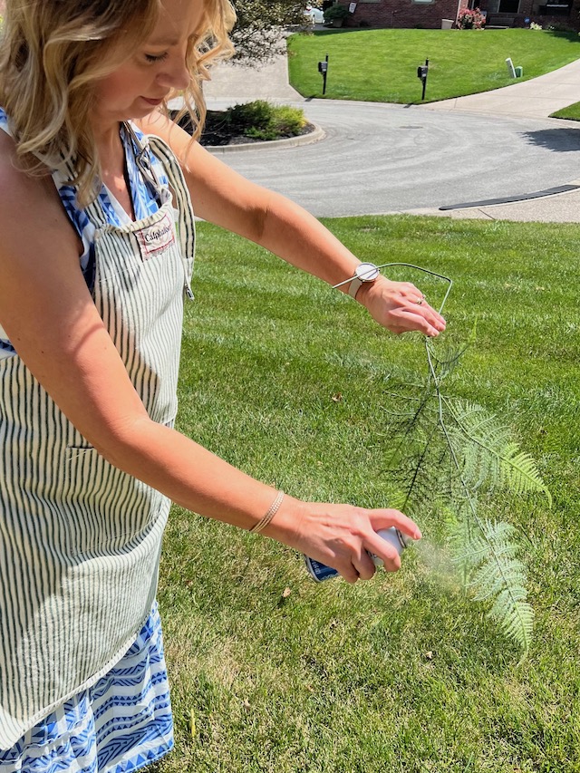 Spray the faux fern with adhesive.